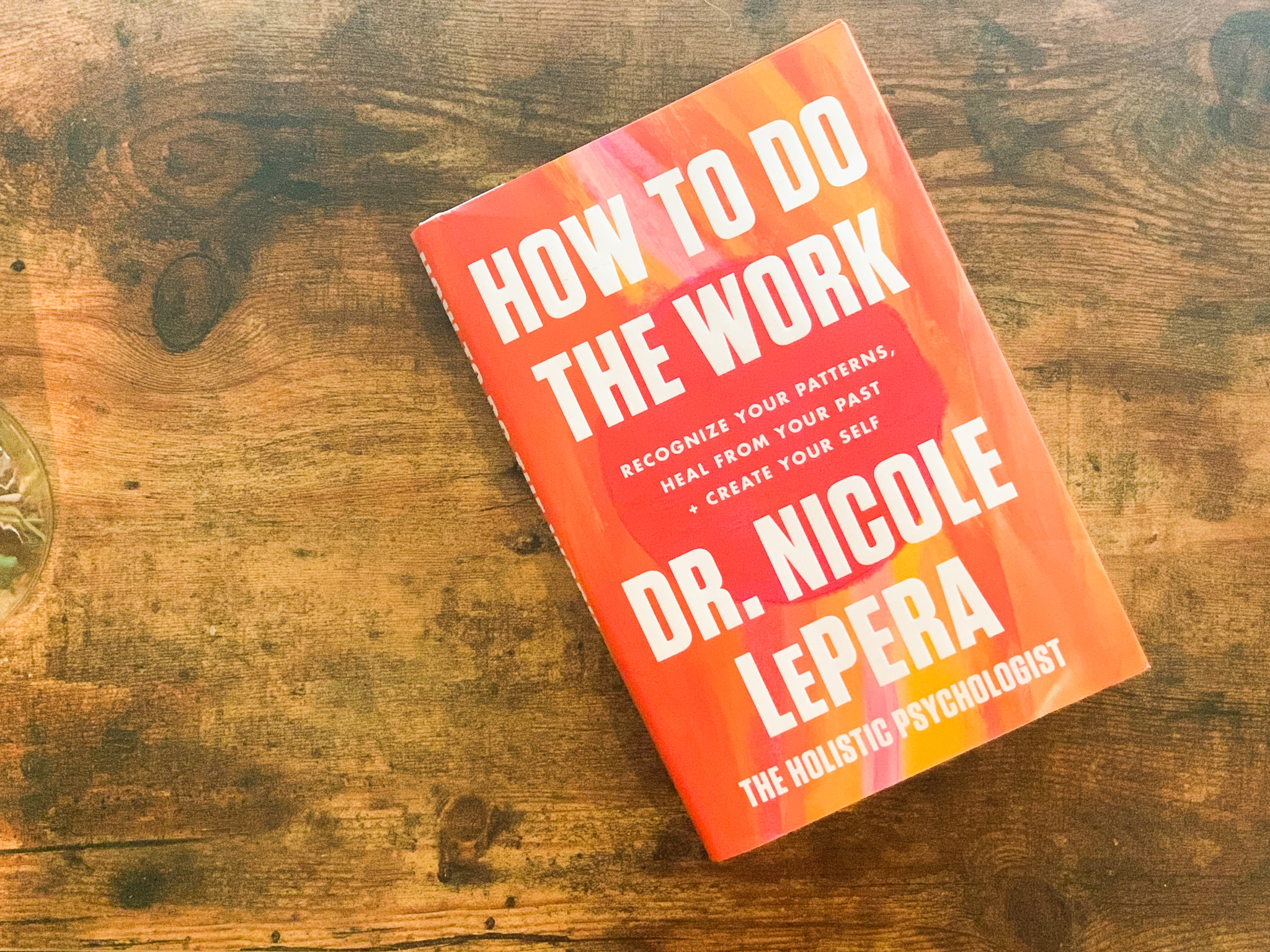 How To Do The Work Book by Nicole LePera sitting on wooden table